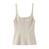 Ivory zip front peplum top flat lay showing the scoop neckline and wide straps