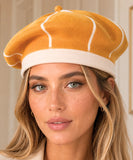 Marigold wool beret with an ivory contrasting ribbed band, side view
