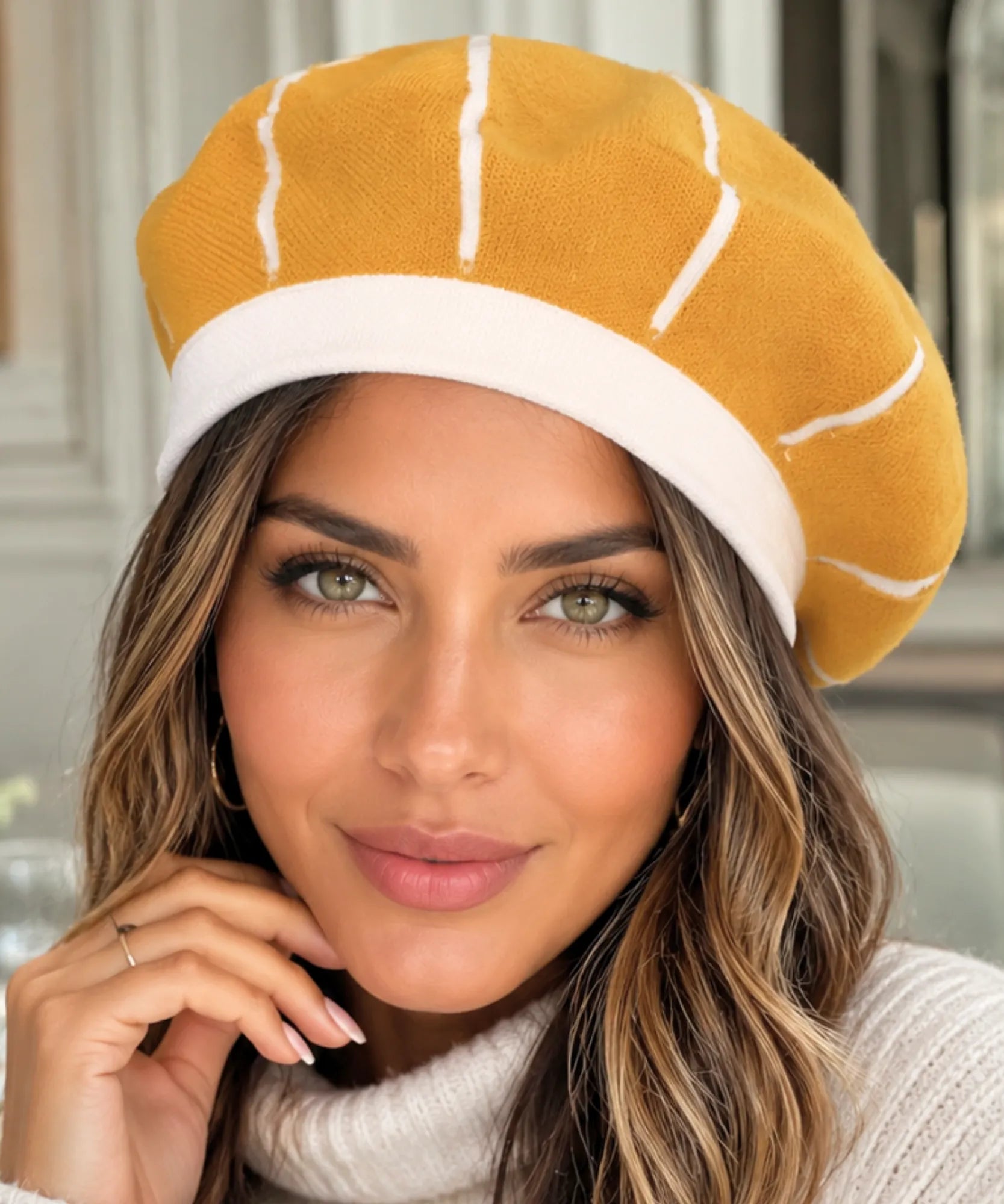 Close-up of a marigold wool beret's contrasting ribbed band