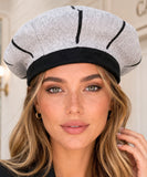Grey wool beret with a black contrasting ribbed band, side view