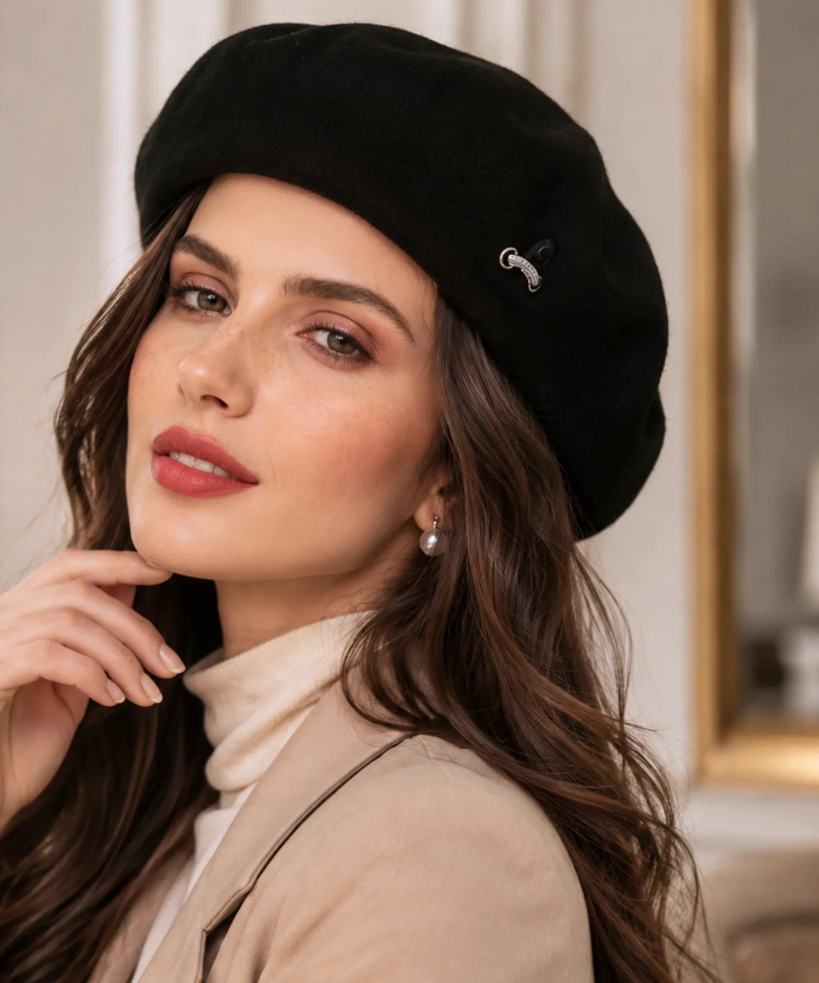 Close-up of a black wool-blend French beret with its metal brooch detail