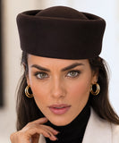 Woman wearing a dark brown wool pillbox hat