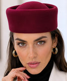 Burgundy wool pillbox hat shown with its satin interior lining