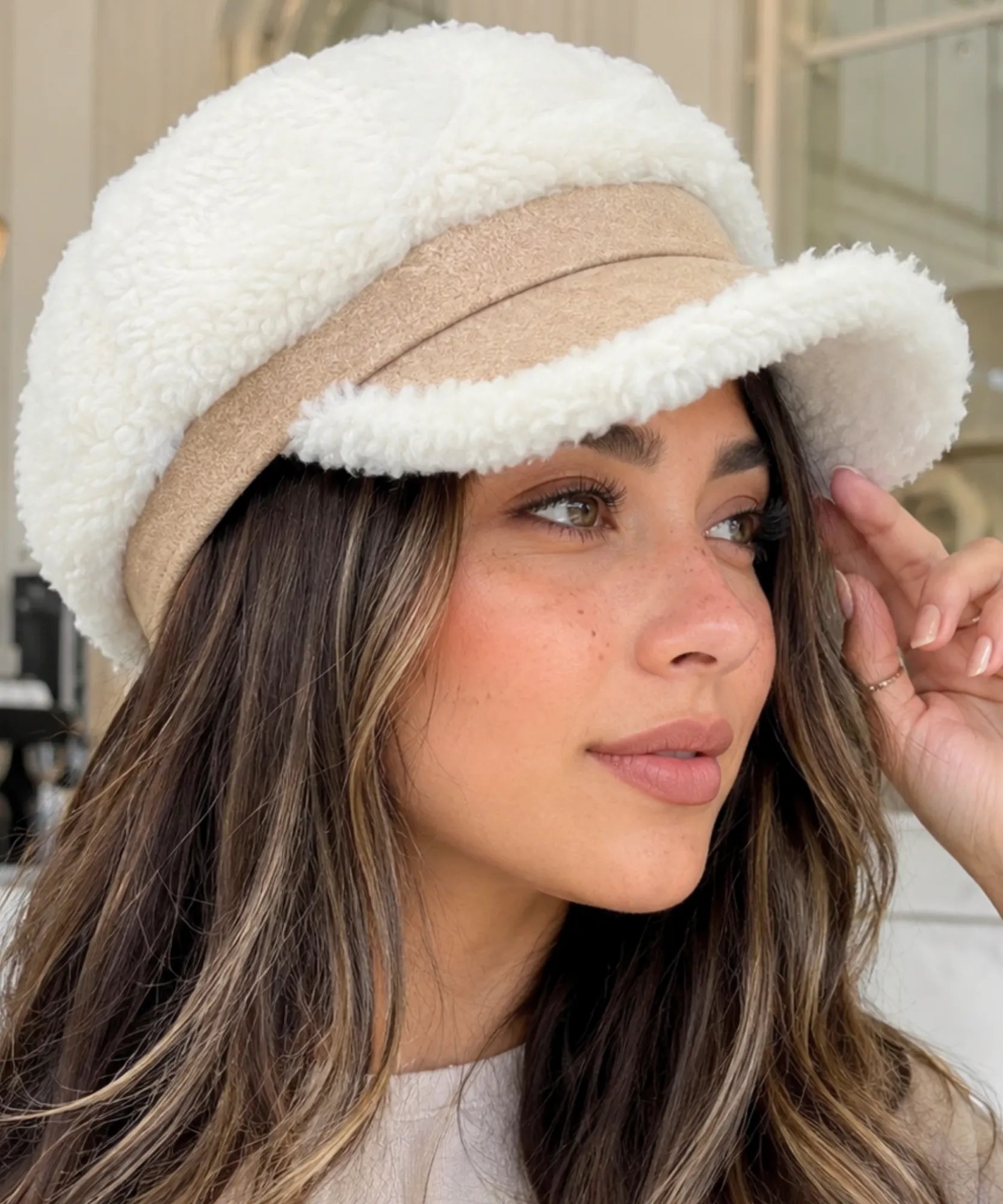 Ivory plush sherpa newsboy cap styled with a matching winter look