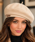 Woman wearing an ivory structured twill French beret with a top stem