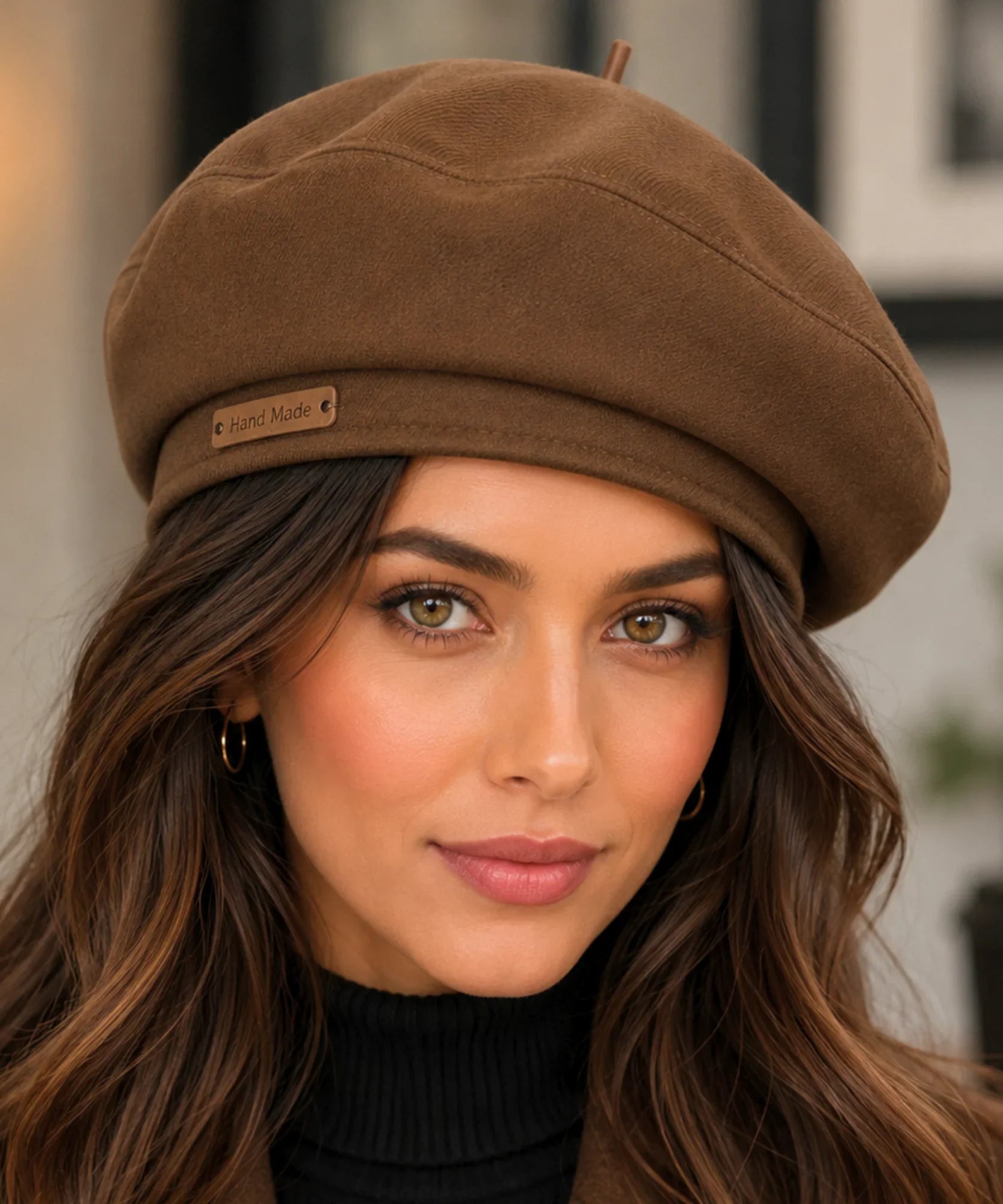 Close-up of a mocha structured twill French beret with a hand-made leather tag