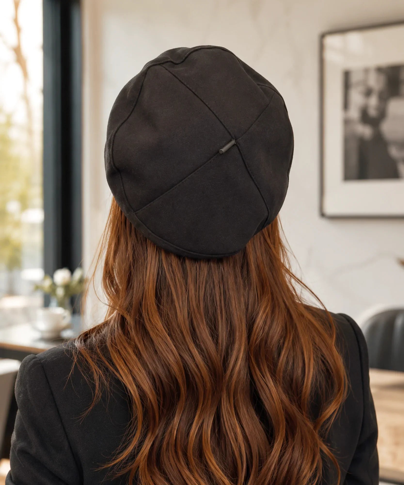 Close-up of a black structured twill French beret with a hand-made leather tag