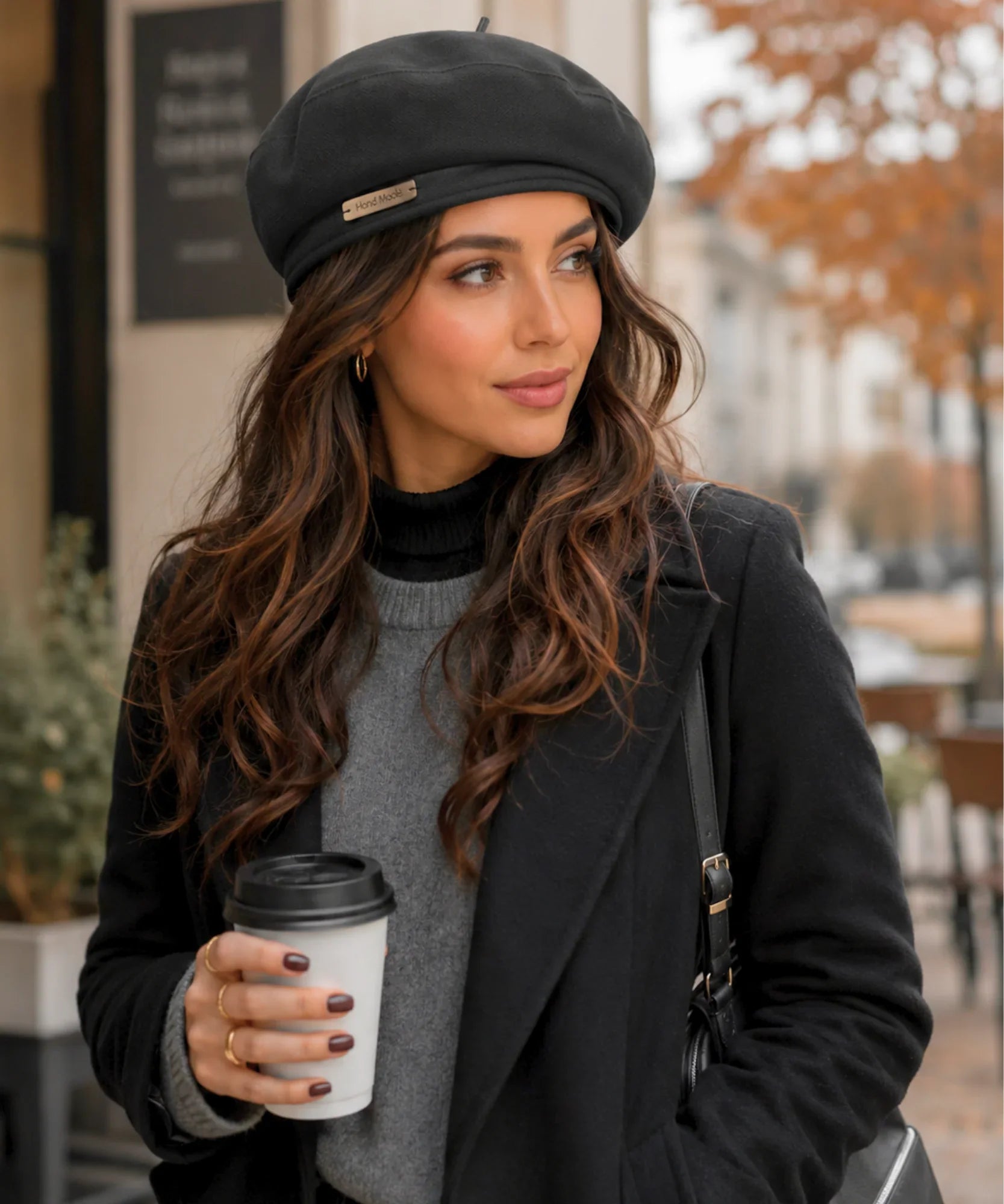 Woman wearing a black structured twill French beret styled with a scarf