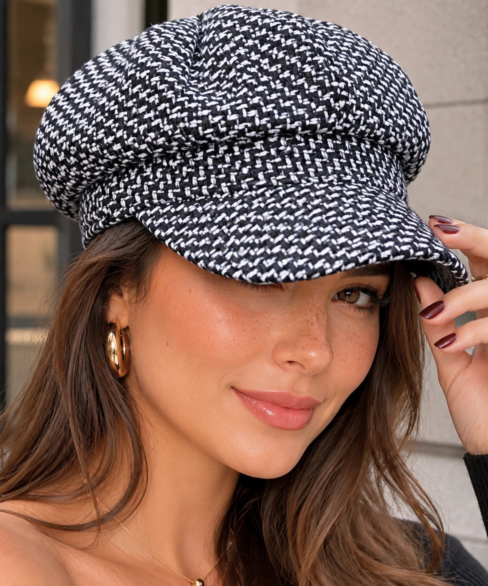 Front view of the black houndstooth tweed newsboy cap