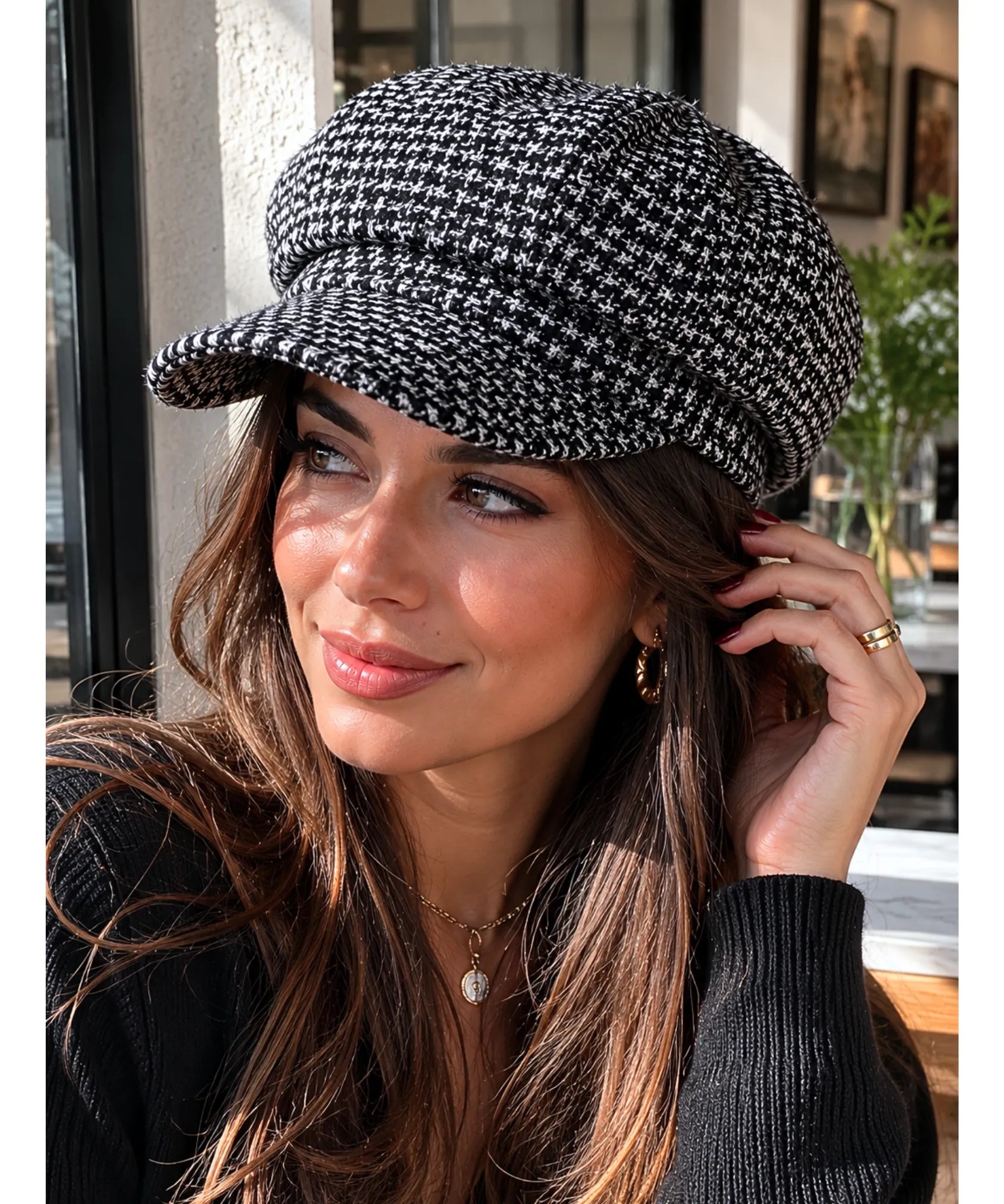 Side profile view of the black houndstooth tweed newsboy cap