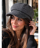 Side profile view of the black houndstooth tweed newsboy cap