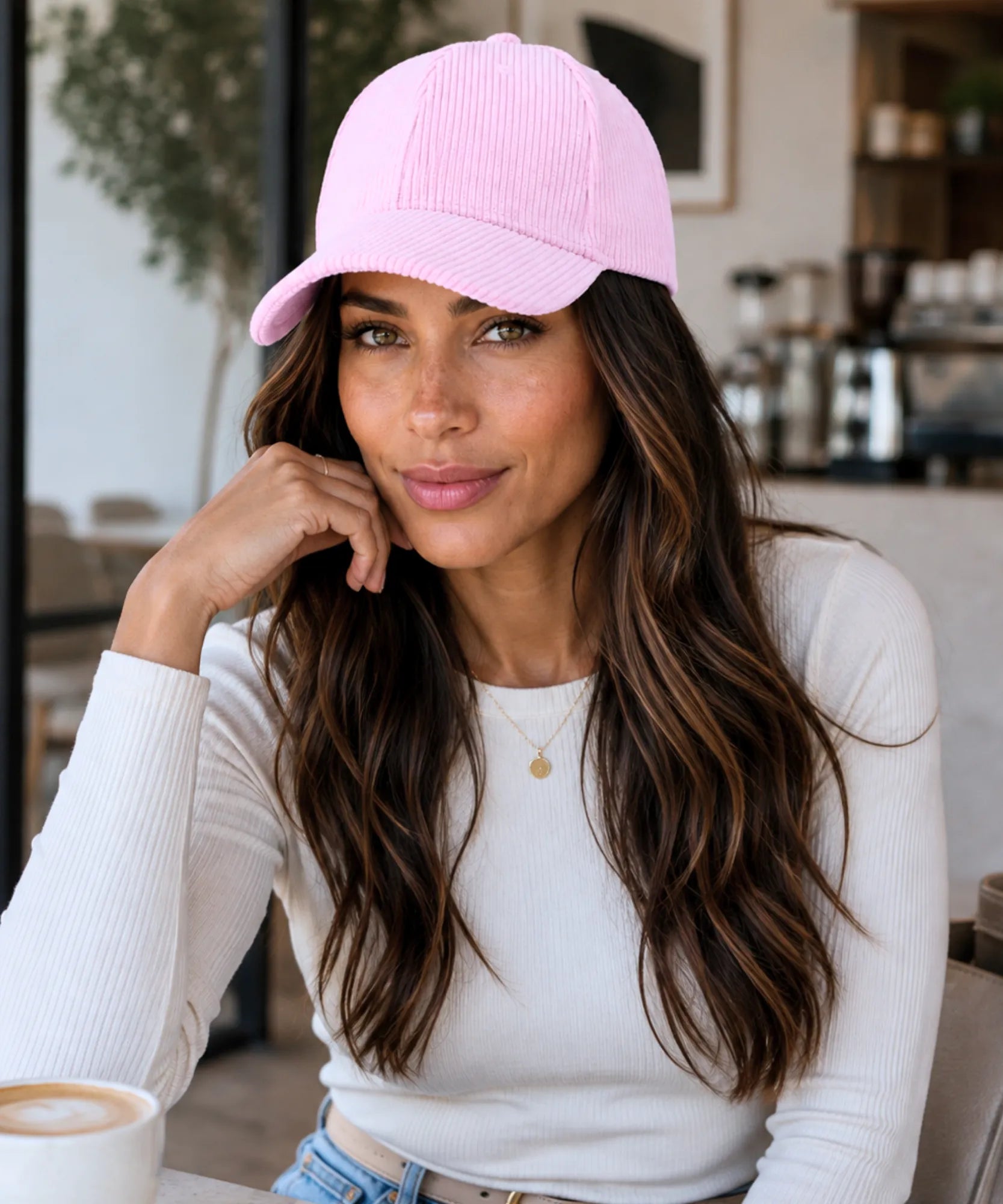 Women's corduroy baseball cap in light pink, styled with a white top