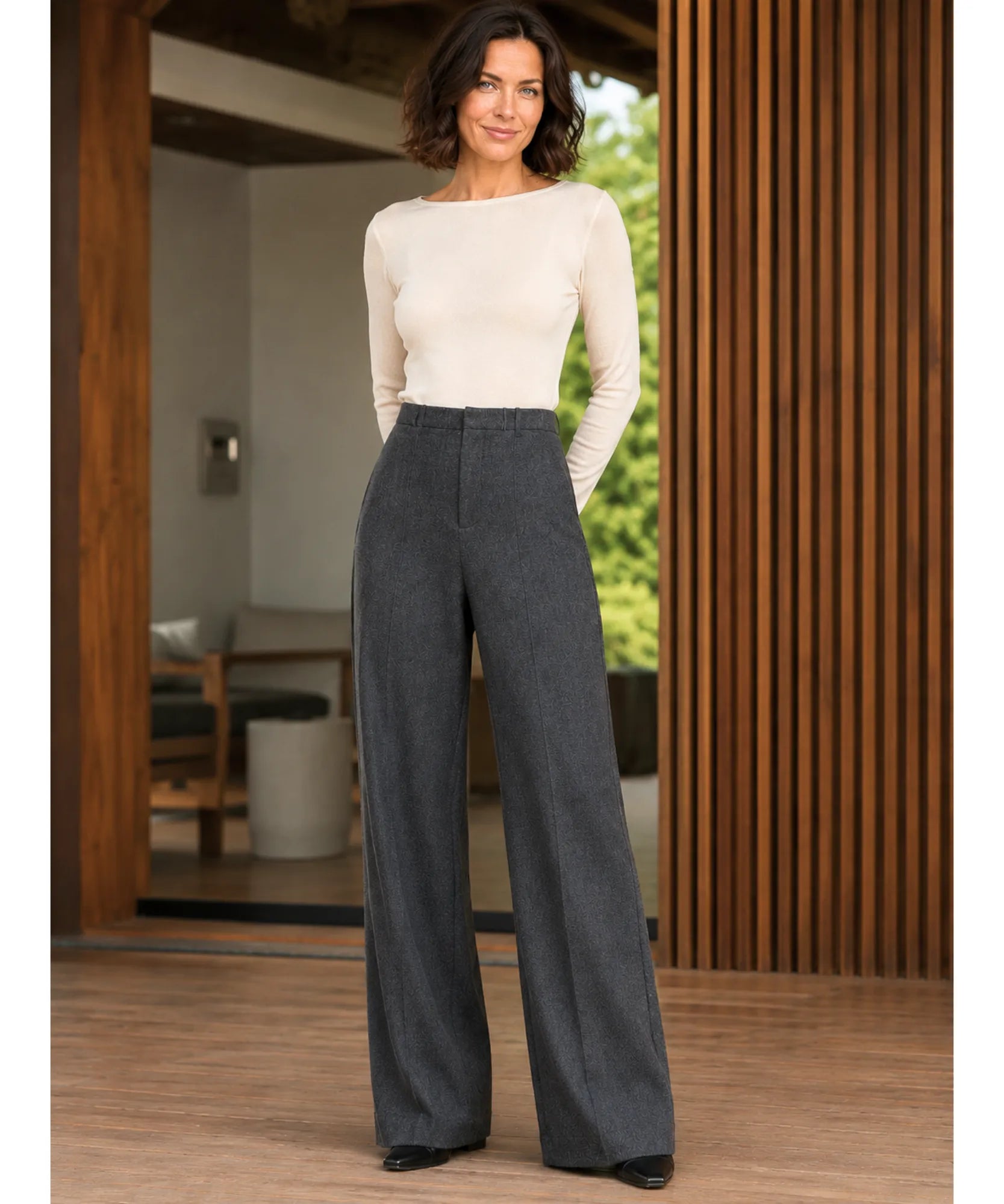Full length view of charcoal wide leg trousers styled with a light top