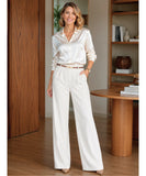 Women's high waisted wide leg trousers in ivory styled with a satin shirt