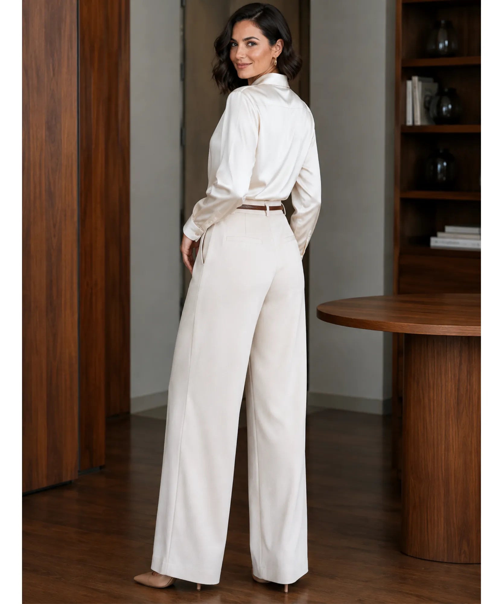 Back view of ivory high waisted wide leg trousers with a white satin shirt