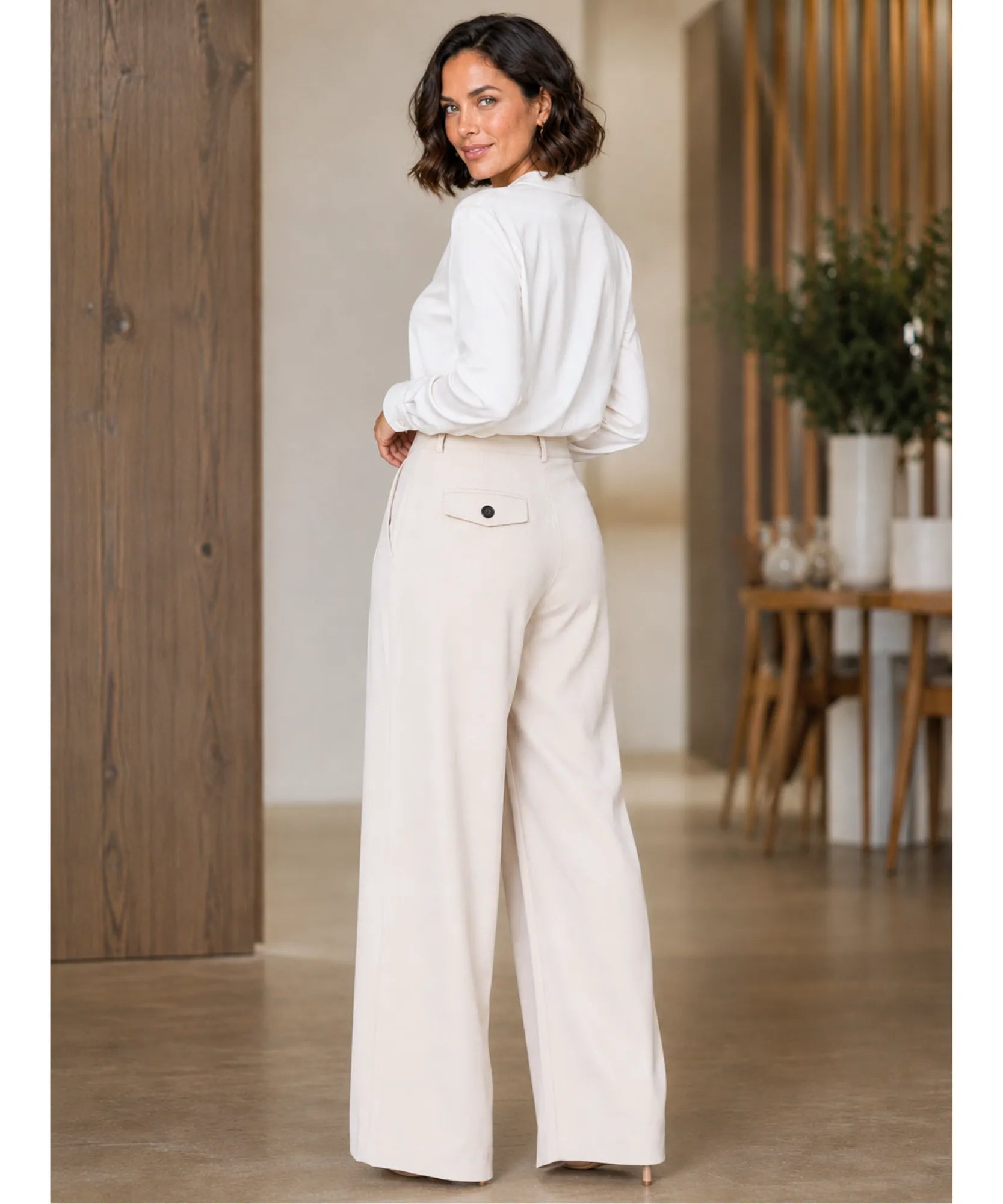 Back view of ivory wide leg wrap pants with a button flap pocket