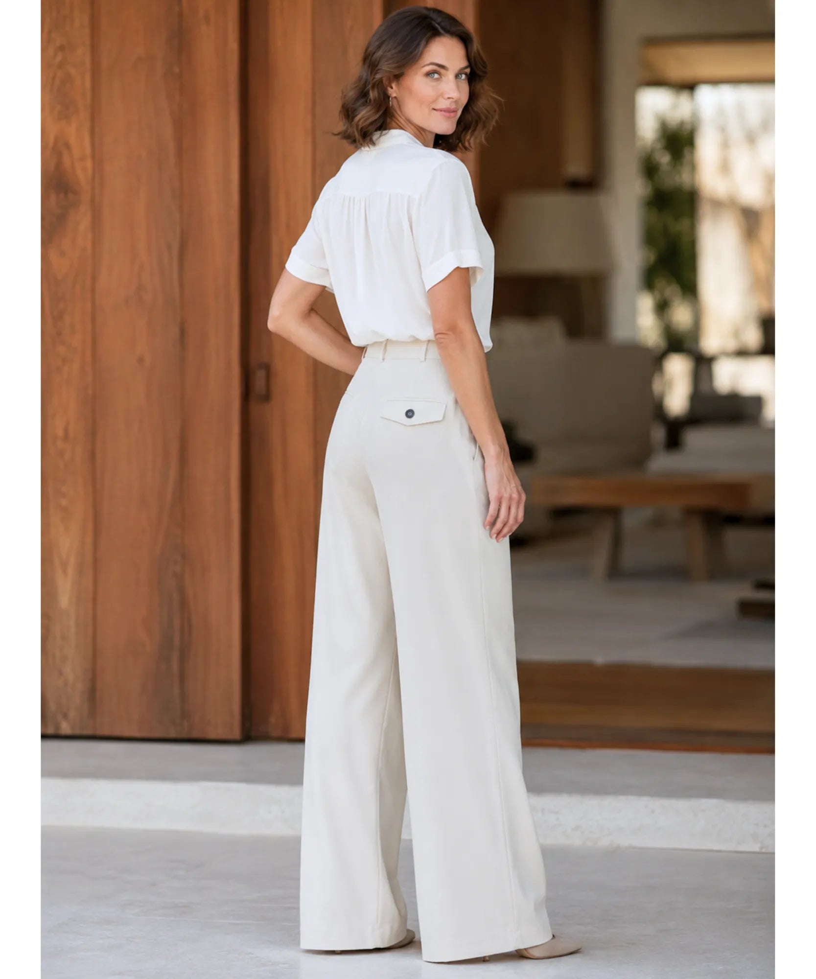 Back view of ivory wide leg wrap pants styled with a short sleeve blouse