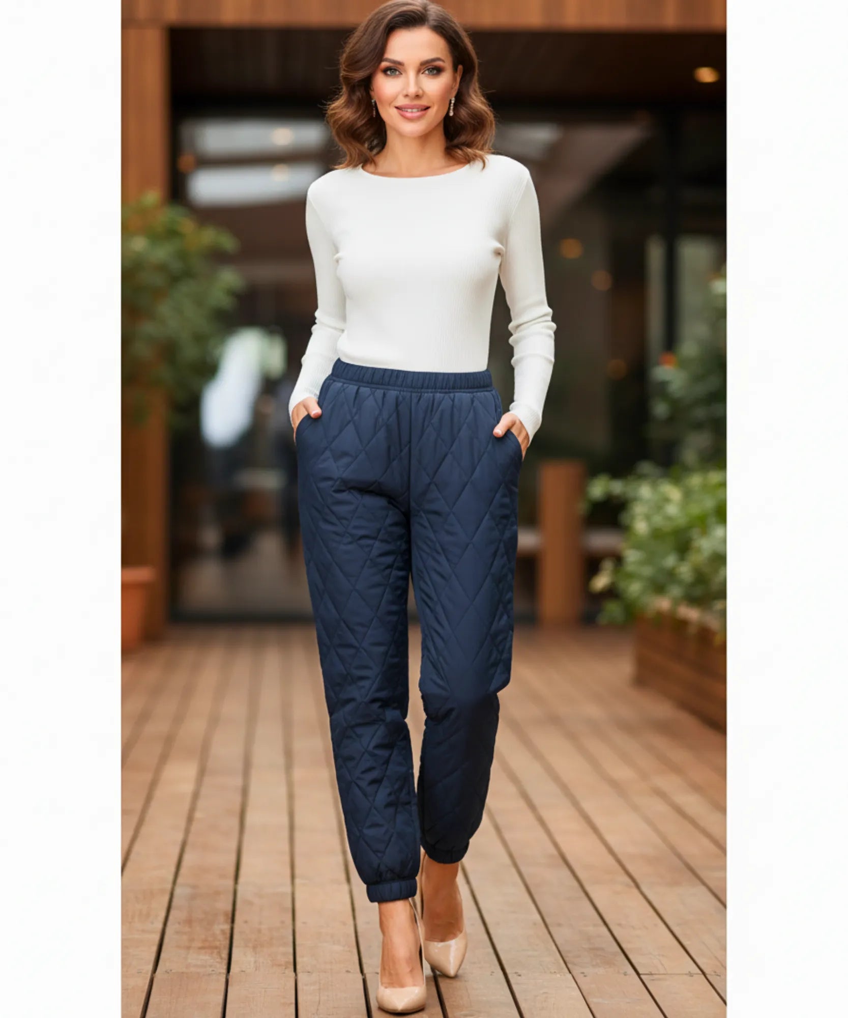 Woman wearing navy quilted joggers with diamond stitching
