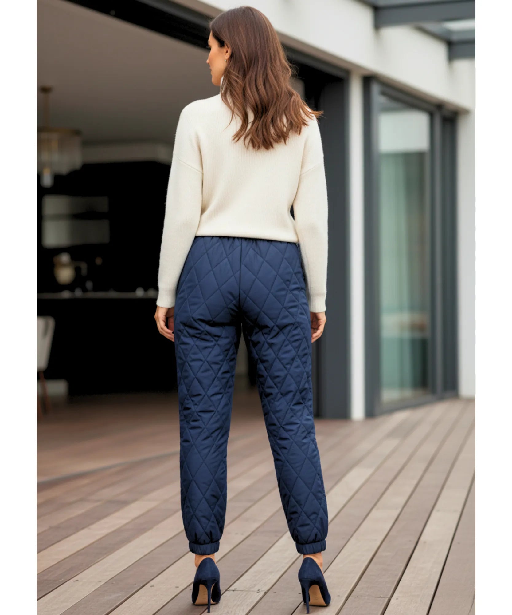 Close-up of navy quilted joggers showing the diamond-stitch pattern