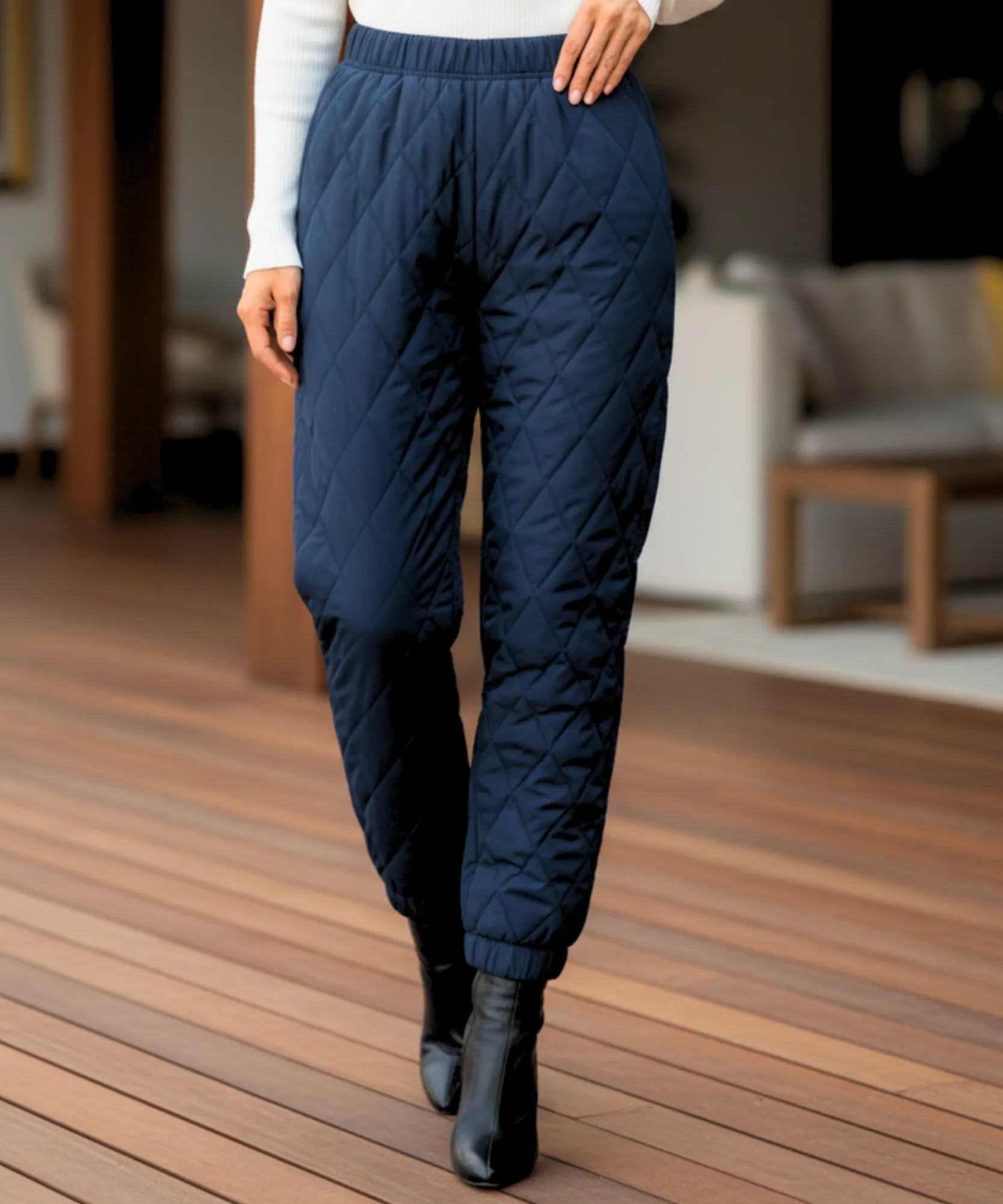 Woman wearing navy quilted joggers with diamond stitching