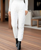 Woman wearing white quilted joggers with ribbed cuffs
