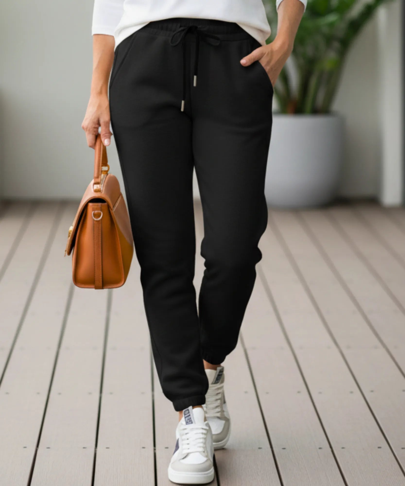 Woman wearing black sherpa-lined joggers, front view