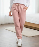 Close-up of hot pink sherpa-lined joggers showing the fabric texture