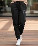 Women's fleece-lined sweatpants in black, close-up of fabric