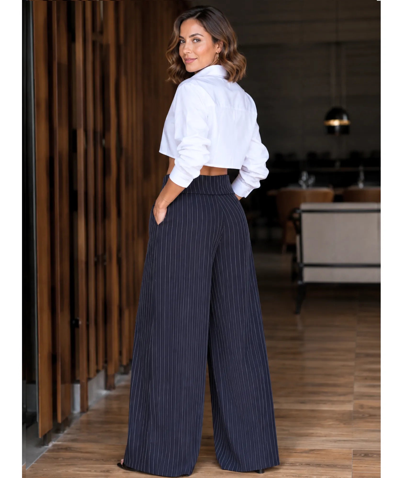 Women's navy pinstripe wide leg pants with a tie waist front view