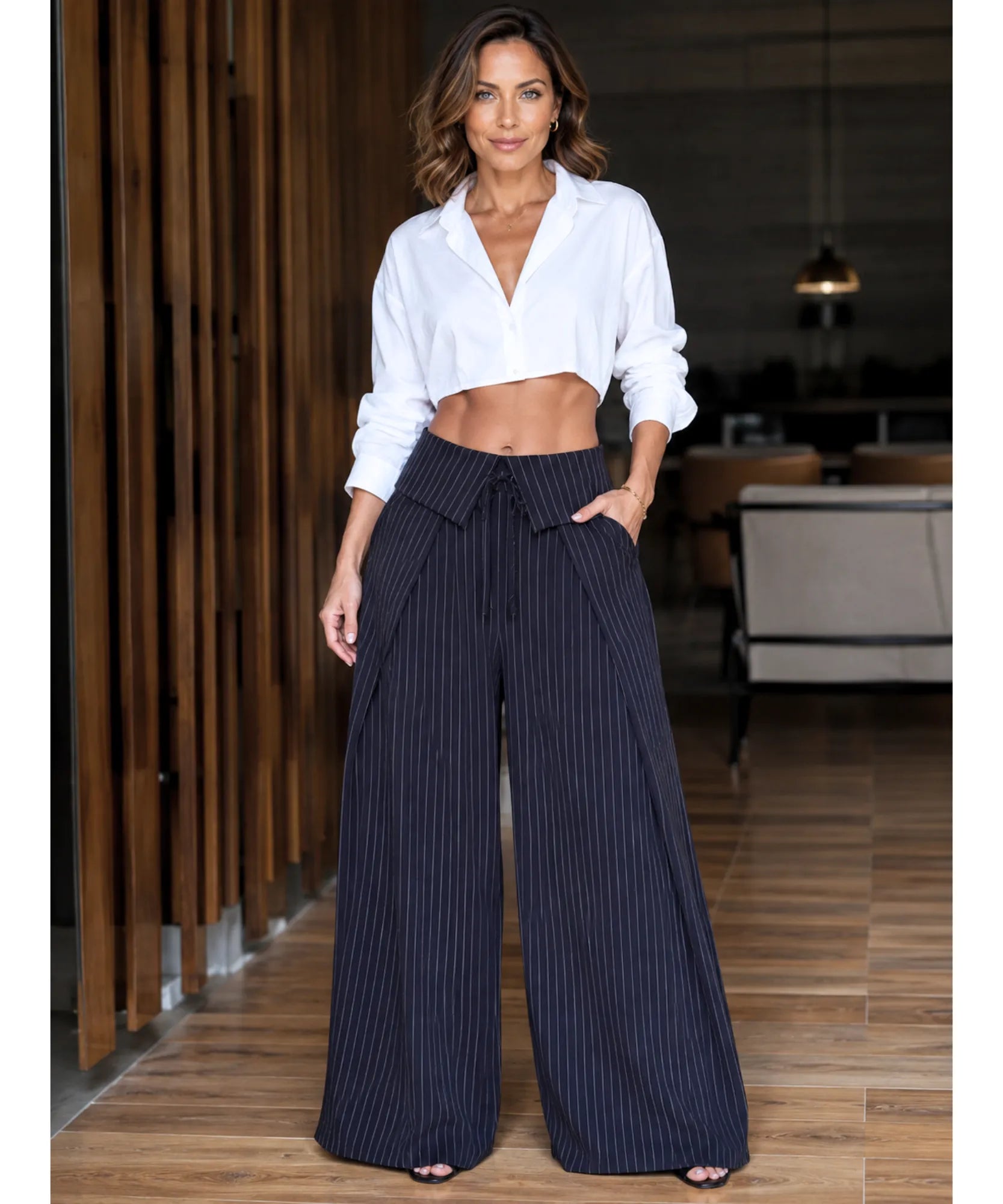 Women's navy pinstripe wide leg pants with a tie waist styled with a white shirt