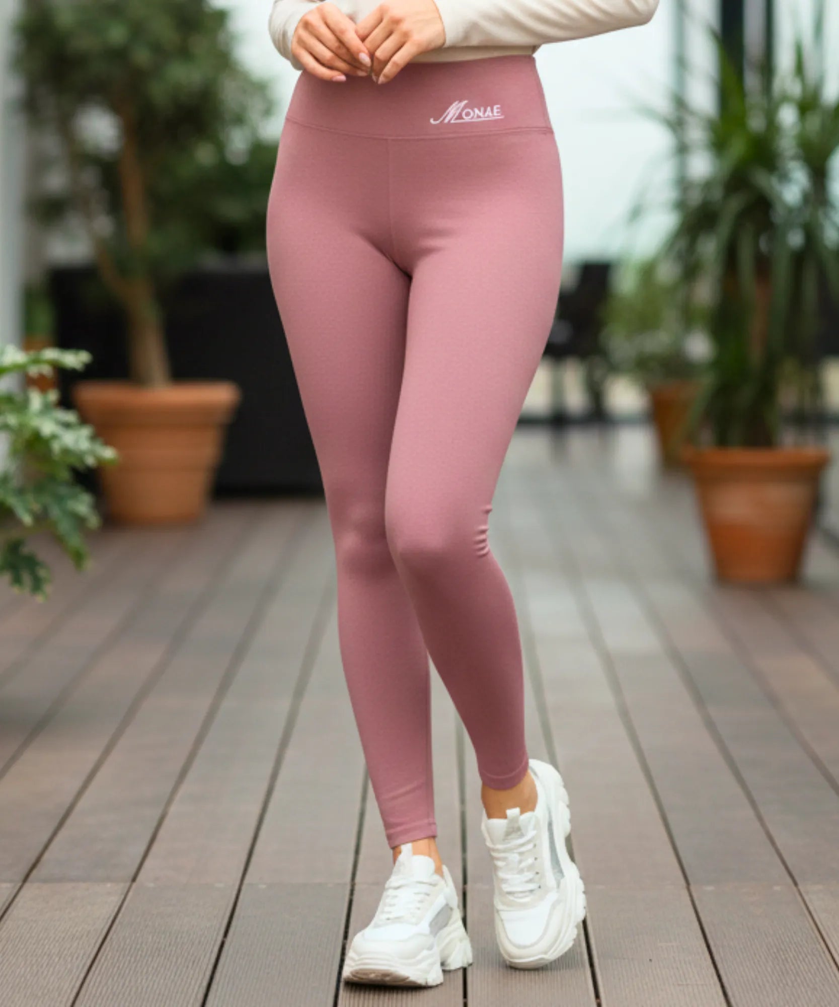 Woman wearing pink fleece-lined leggings with a brushed flannel exterior