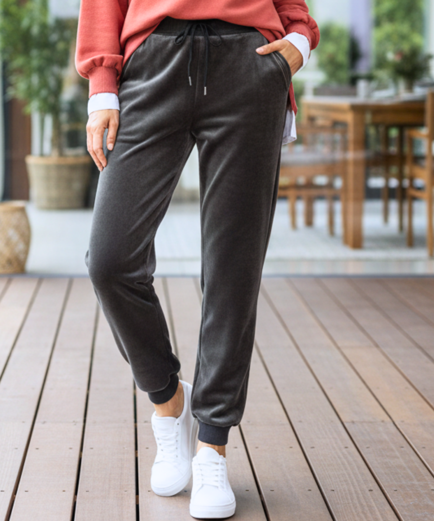Woman wearing charcoal grey velvet joggers with a sherpa lining