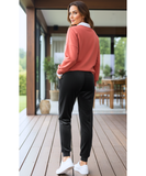 Woman wearing black velvet joggers with a sherpa lining