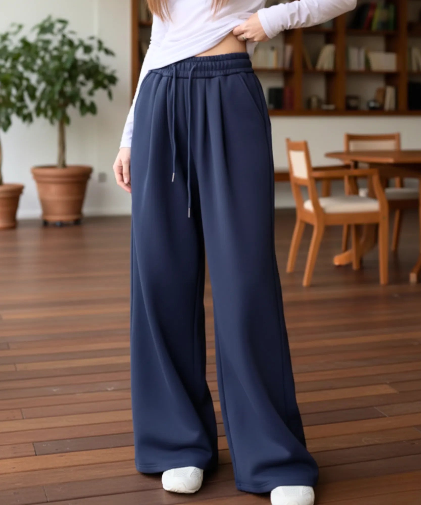Woman wearing navy fleece-lined wide-leg sweatpants