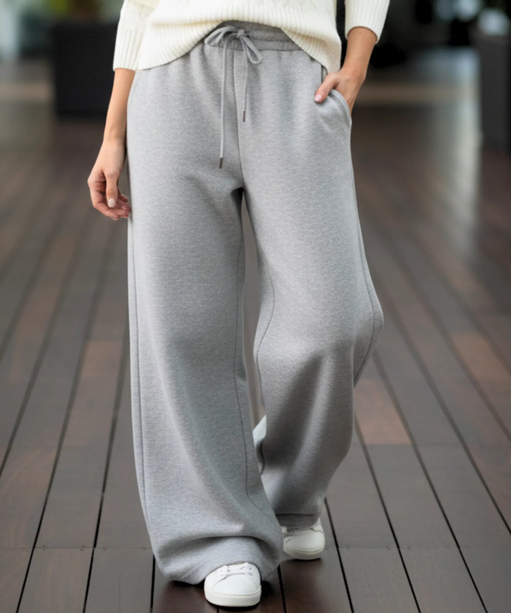 Woman wearing grey fleece-lined wide-leg sweatpants
