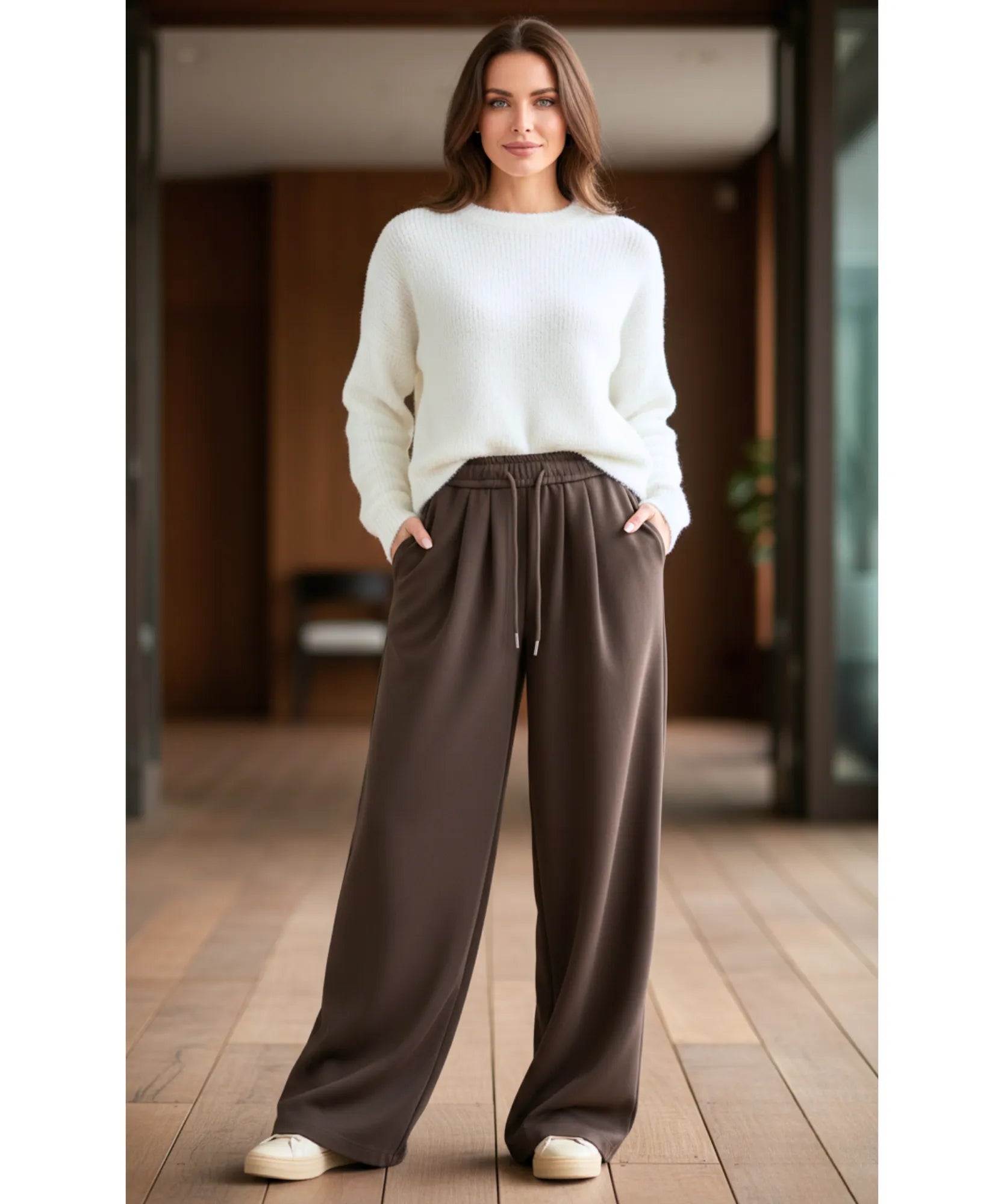 Woman wearing dark brown fleece-lined wide-leg sweatpants, front view