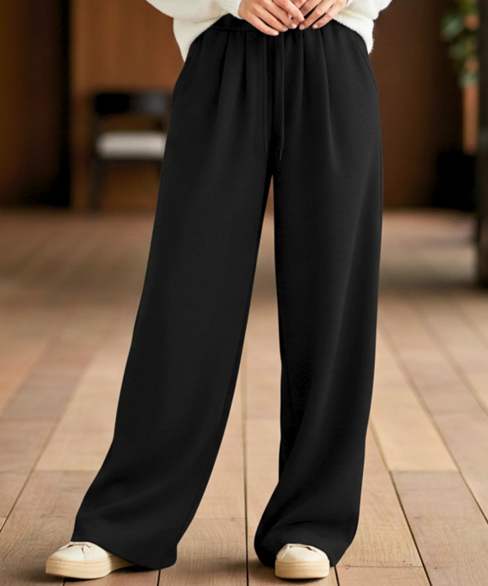 Woman wearing black fleece-lined wide-leg sweatpants