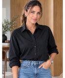 Women's black button up shirt with long sleeves and blue jeans
