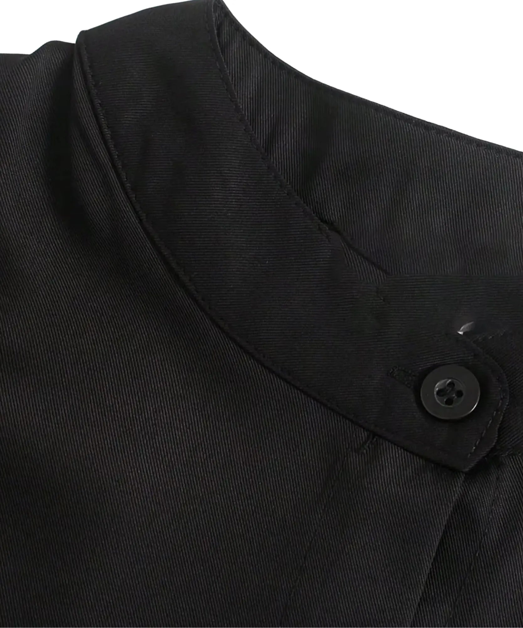 Women's close-up of a black shirt mandarin collar and button tab