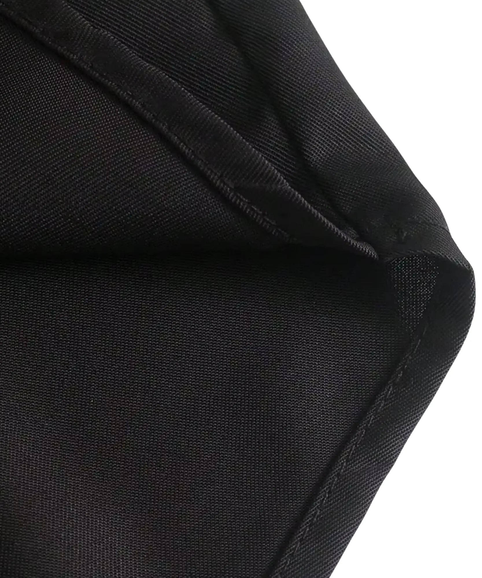 Women's close-up of black polyester shirt fabric and seam detail