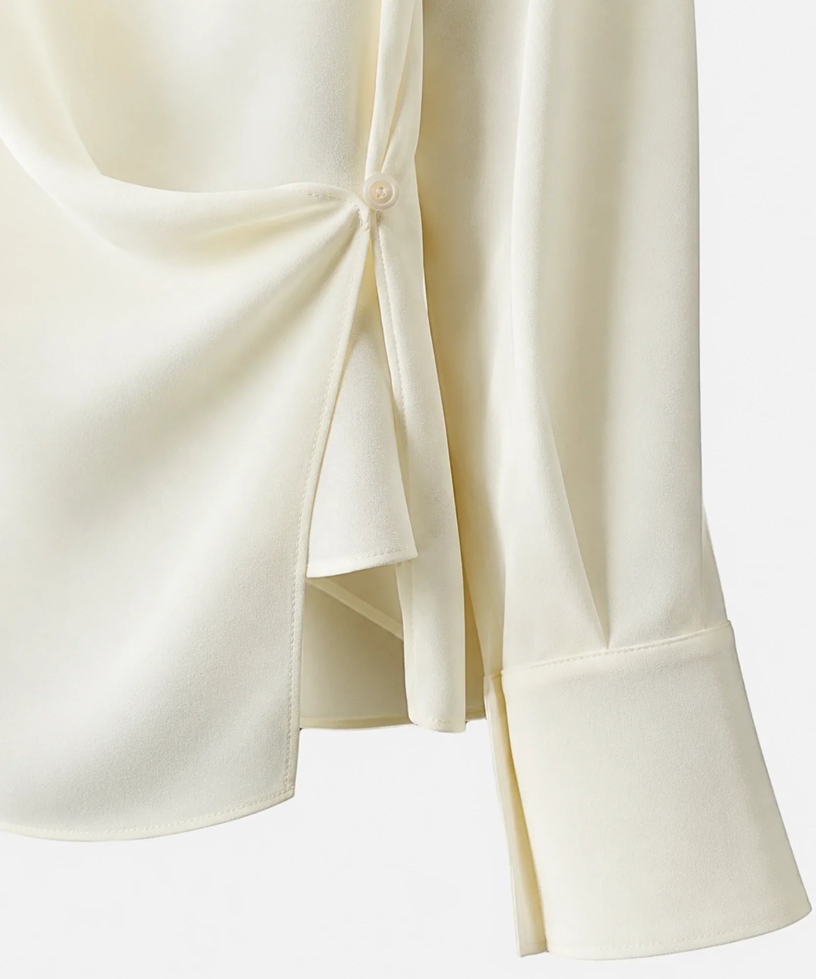 Close-up of the fabric and round collar on the ivory wrap blouse