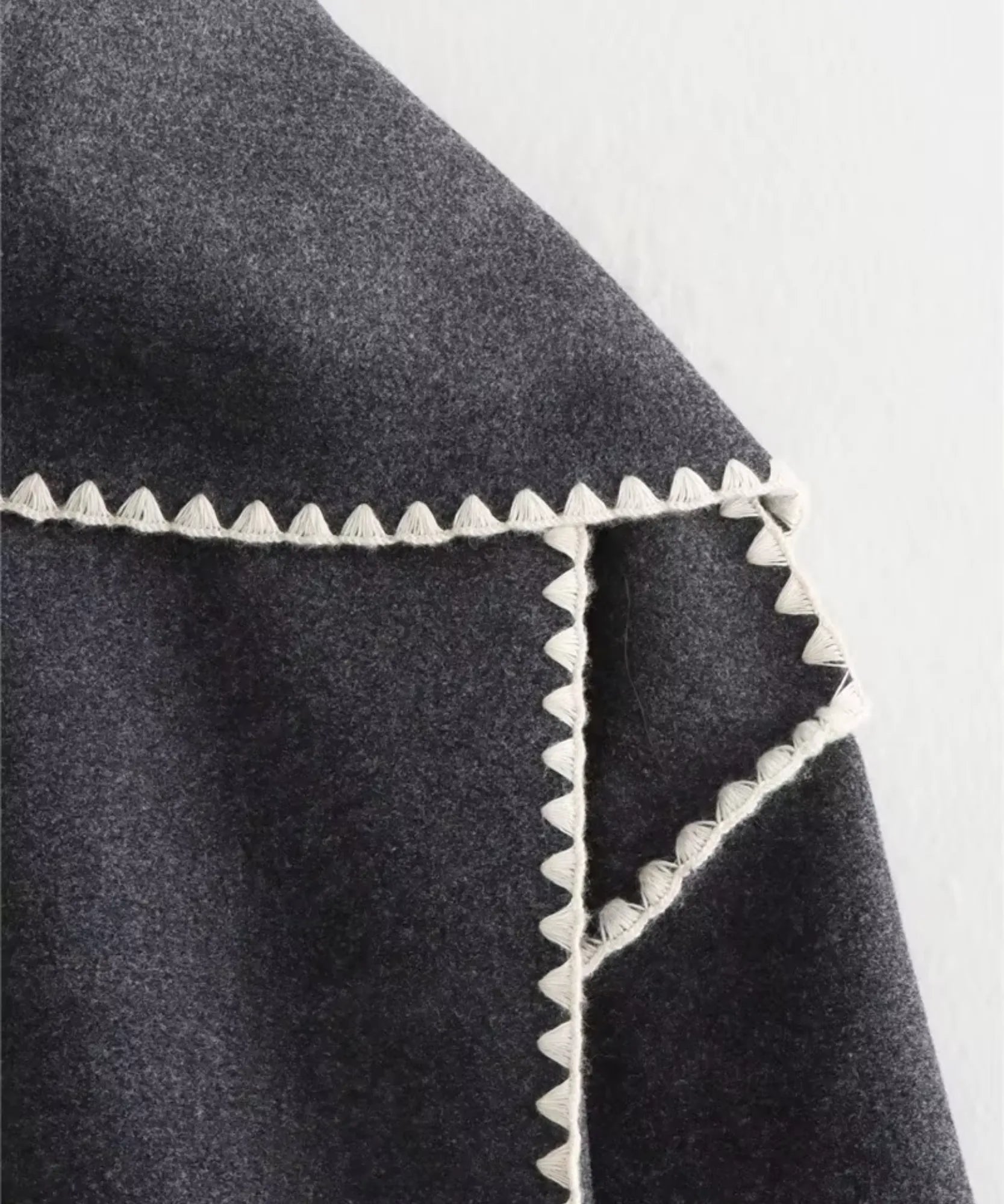 Woman styling the grey wool cape coat outdoors