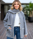 Close-up of the charcoal wool coat's draped collar