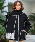 Woman wearing a wool cape coat in black