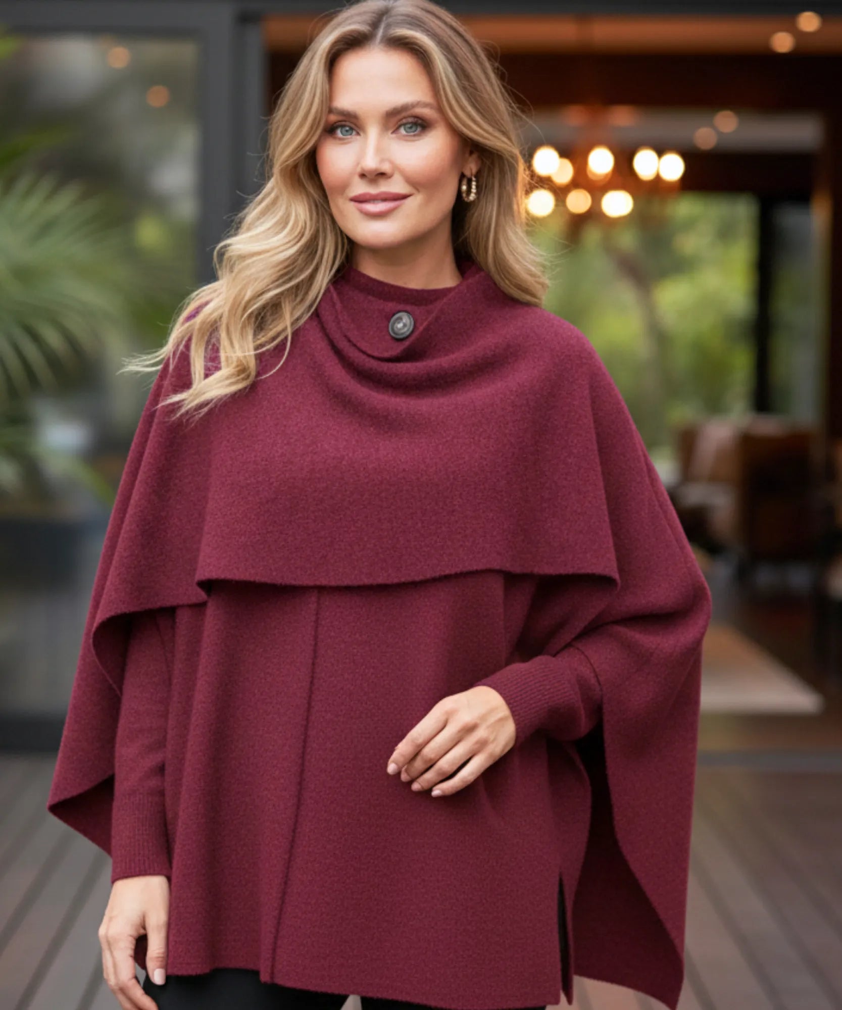 Woman wearing an oversized wool wrap coat in burgundy