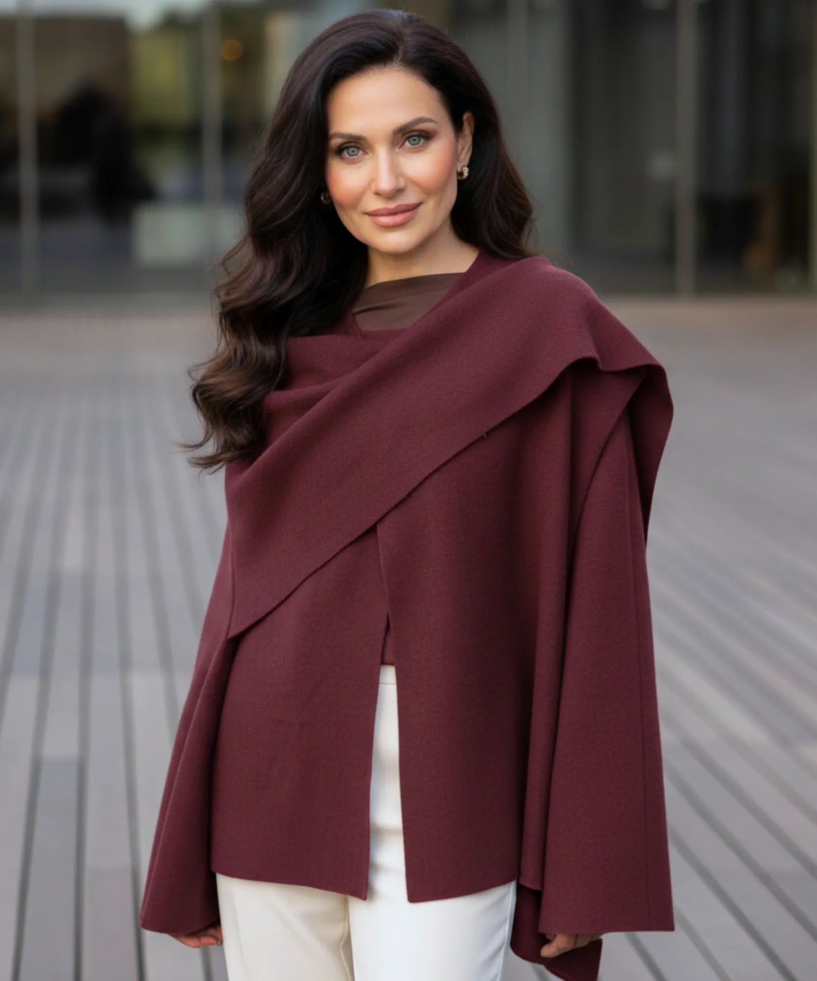 Woman styling the burgundy wool wrap coat outdoors