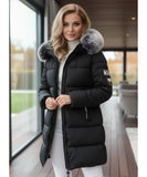 Woman wearing a long hooded parka coat in black