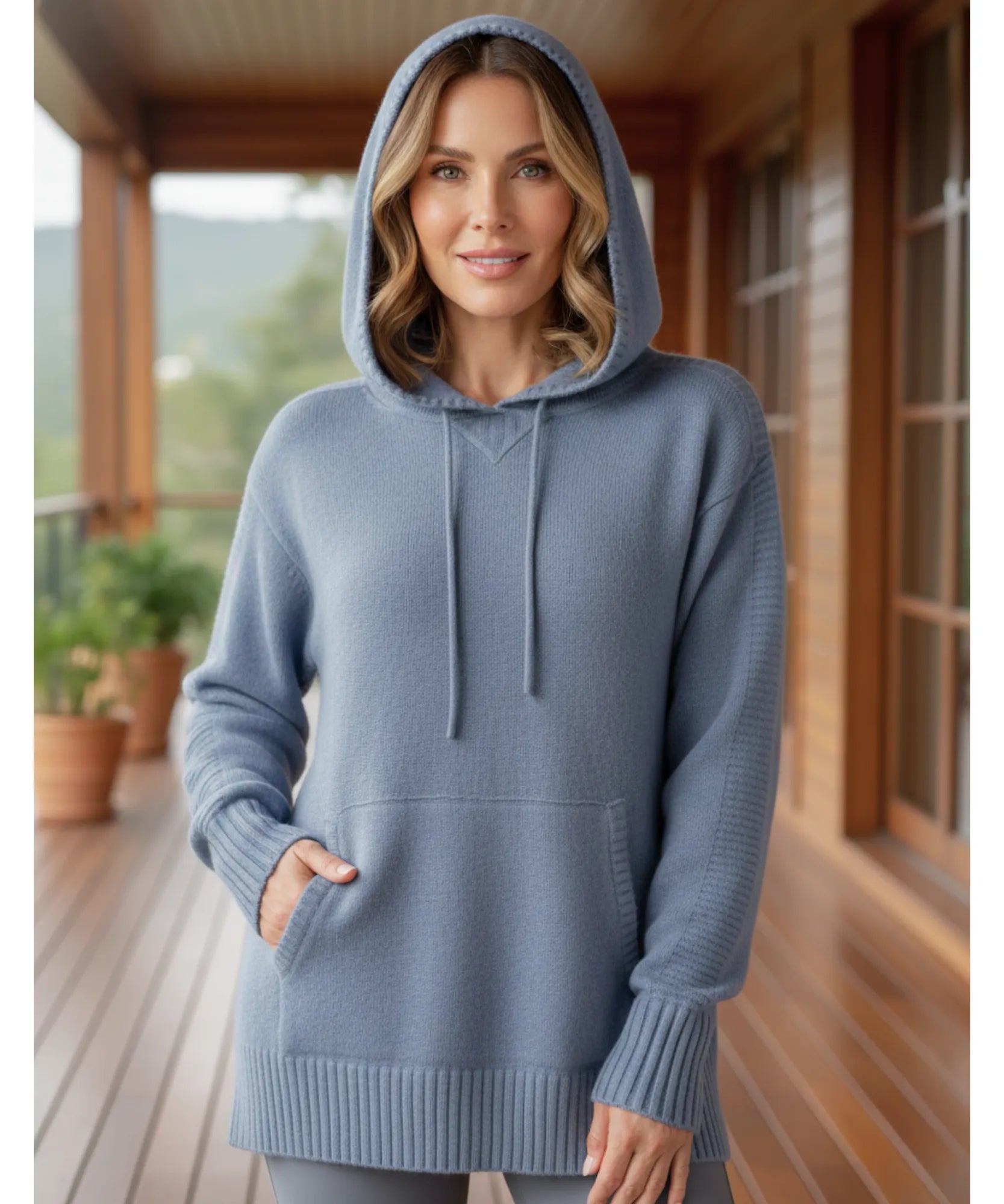 Women's knit hooded sweater in dusty blue with the hood up