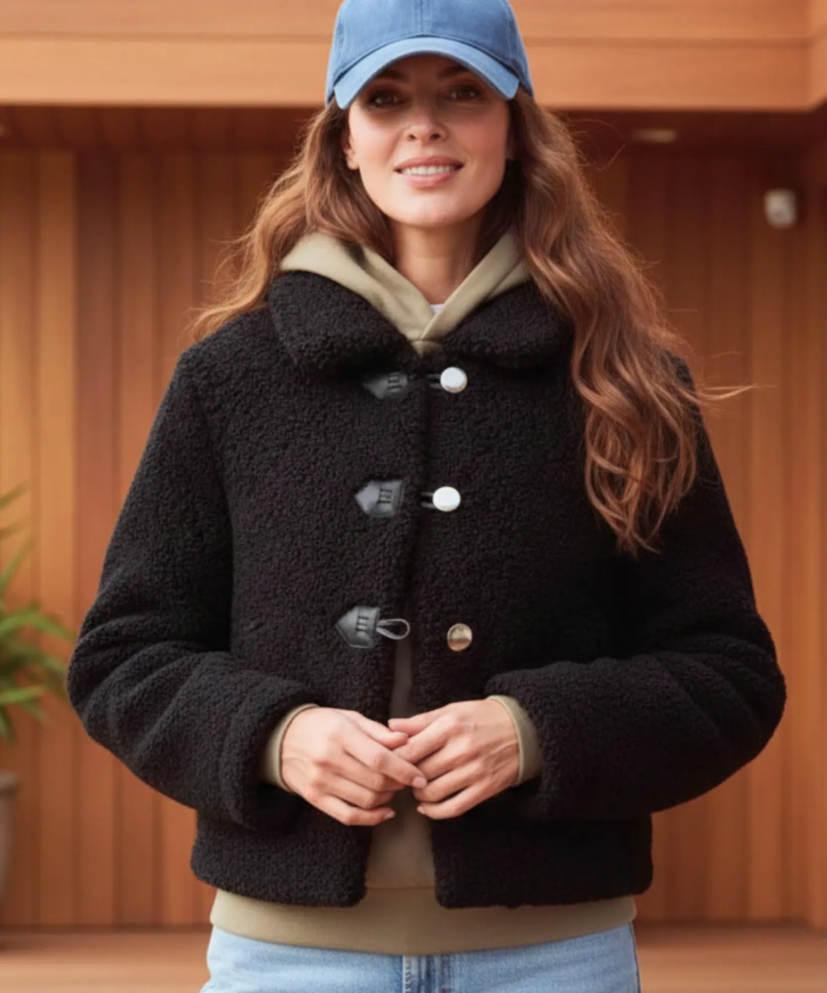 Detail of the toggle closure on the black teddy coat