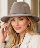 Woman wearing a Taupe wide-brim suede western hat